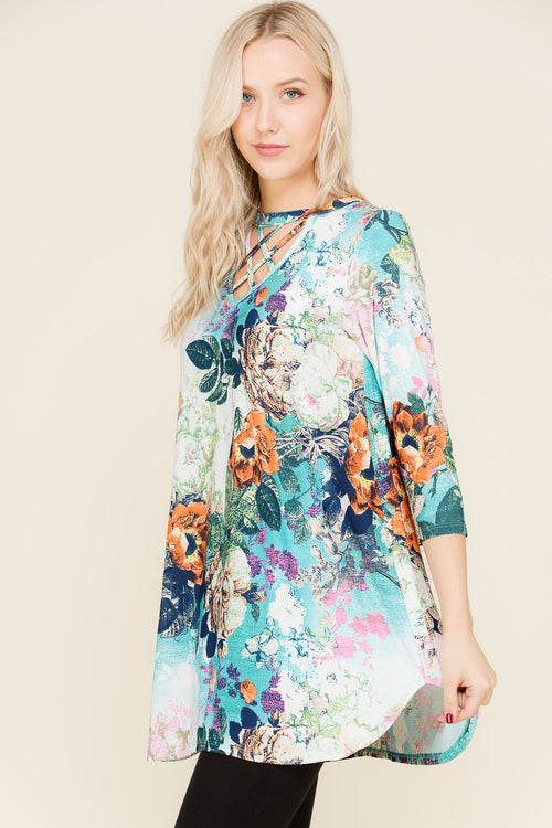 This turquoise floral tunic with a criss-cross front is perfect for a night of dancing or just going to a show. Dress it up or down and look fabulous.