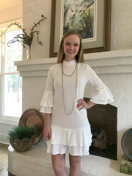 You will look beautiful in this ivory dress with ruffle detail in the sleeves and hem. It is so elegant. It has a mock neck that fits comfortably.  