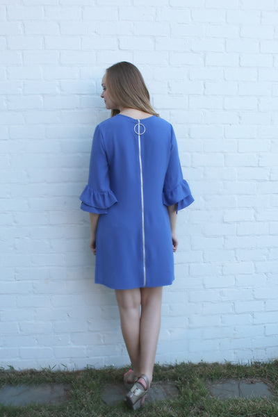 This showstopping periwinkle ruffle bell sleeve dress is sure to turn heads. The full zipper detail down the back is amazing! We have paired it with our silver tassel necklace found in our accessories collection.