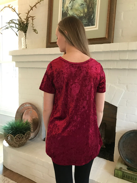 This lovely updated red velvet short sleeve tee with twist front detail is so feminine. Wear it with your favorite jeans and our red beaded tassel necklace. 