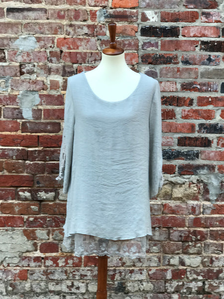 Dress this gorgeous silver top up or down all year. Delicate lace adorns the hem adding additional softness. Perfect for a work event, holiday party or a night out.   Fits true to size: Small 2/4, Medium 6/8, Large 10-12